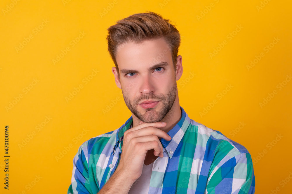 Portrait of serious handsome guy think with thoughtful face yellow background, thinking Portrait of serious handsome guy think with thoughtful face yellow background, thinking