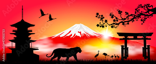 Tiger on the background of Mount Fuji. Tiger as a symbol of the upcoming New Year according to the Eastern calendar. Japanese landscape with Mount Fuji. Rising sun, cranes, pagoda and gate