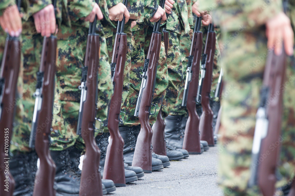 Soldiers in boots and a rifle.Soldiers stand in row. Gun in hand. Army ...