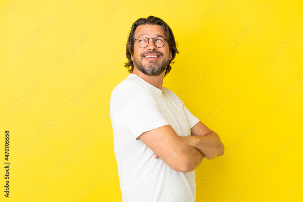 Senior dutch man isolated on yellow background happy and smiling Senior dutch man isolated on yellow background happy and smiling