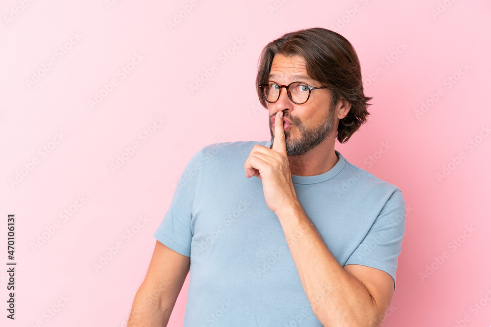 Senior dutch man isolated on pink background With glasses and doing silence gesture Senior dutch man isolated on pink background With glasses and doing silence gesture