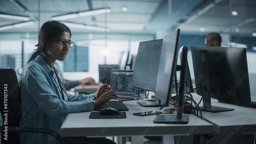 Diverse Office: Indian IT Programmer Working on Desktop Computer. Female Specialist Creating Innovative Software Engineer Developing App, Program, Video Game. Terminal with Coding Language.