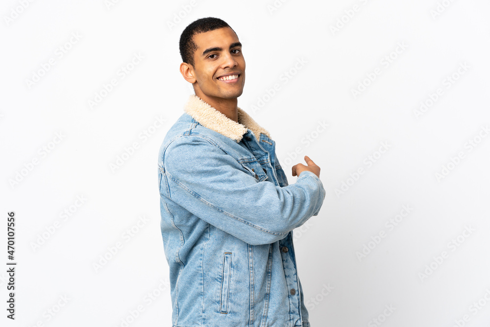 African American man over isolated white background pointing back African American man over isolated white background pointing back
