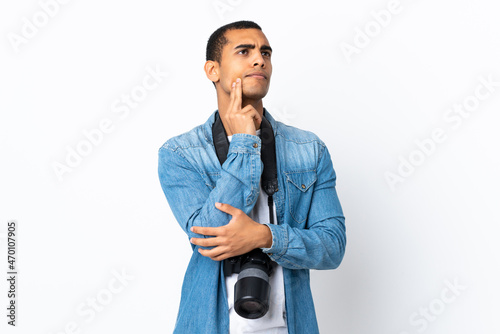 Young African American photographer man over isolated white background thinking an idea