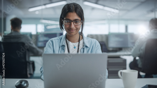 Diverse Office: Portrait of Smiling Indian IT Programmer Working on Desktop Computer. Female Specialist Create Innovative Software. Professional Engineer Develop App. photo