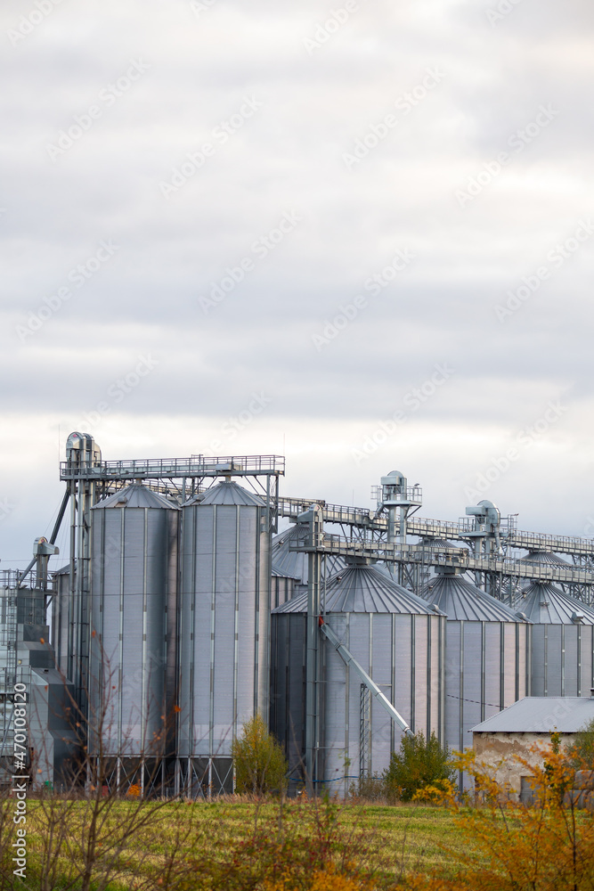 Close-up on steel grain silo in the fields. Photo taken in natural lighting, soft light Close-up on steel grain silo in the fields. Photo taken in natural lighting, soft light