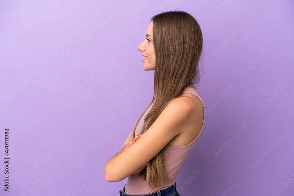 Young Lithuanian woman isolated on purple background in lateral position
