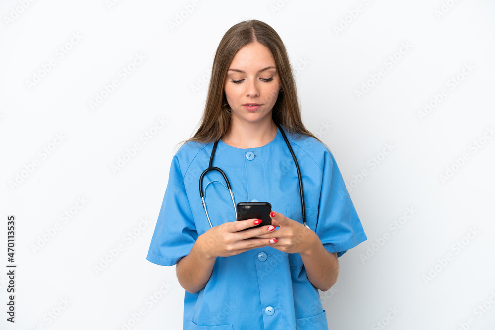 Young surgeon doctor Lithuanian woman isolated on white background sending a message with the mobile
