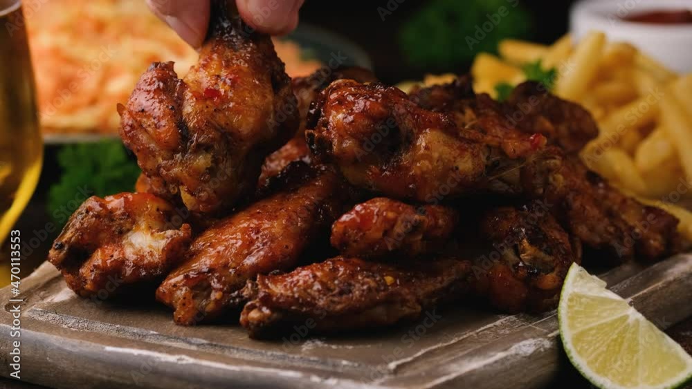 Taking buffalo chicken wings with sesame seeds. fast food