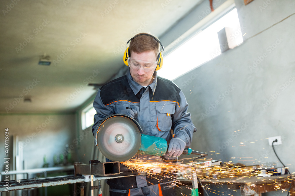 The worker grinds with a metal tube grinder The worker grinds with a metal tube grinder
