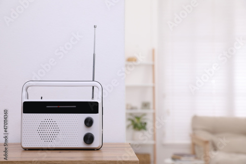 Stylish white radio on table indoors. Space for text