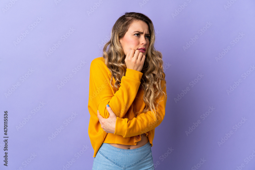 Young Brazilian woman isolated on purple background is a little bit nervous Young Brazilian woman isolated on purple background is a little bit nervous