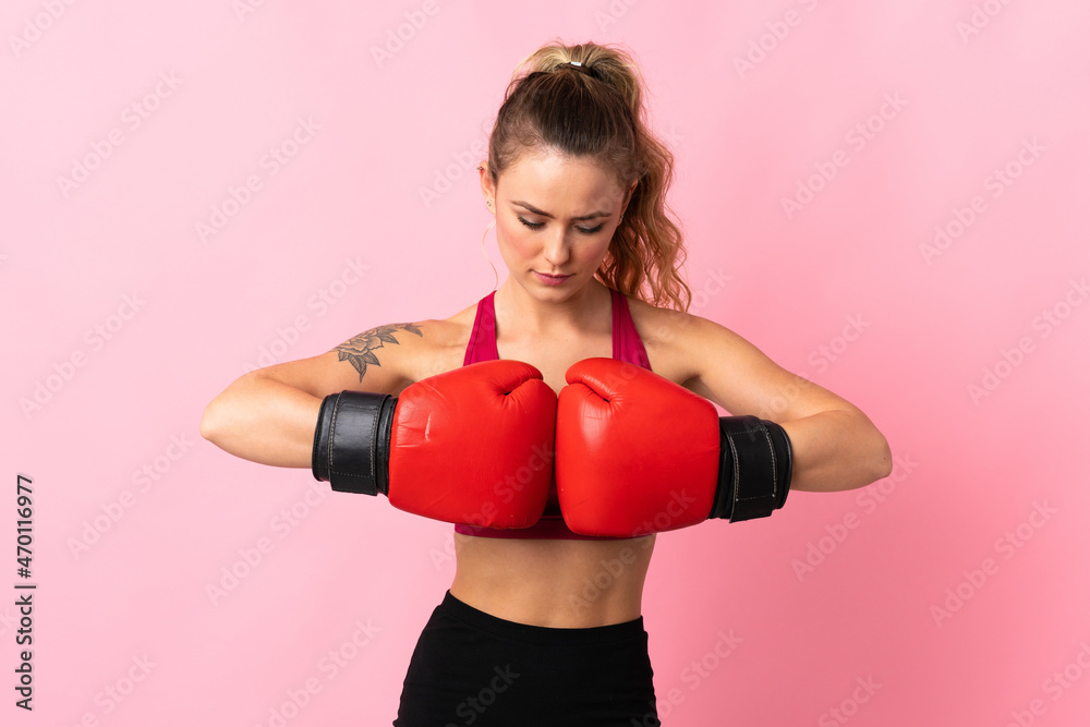 Young Brazilian woman isolated on pink background with boxing gloves