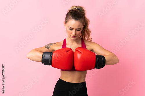 Young Brazilian woman isolated on pink background with boxing gloves © luismolinero