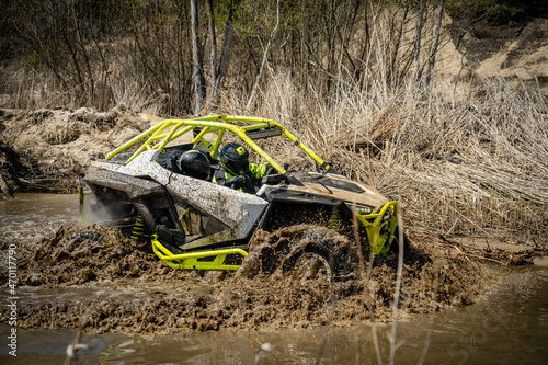 ATV and UTV in action in hard road with water mud splash. Extreme, adrenalin. 4x4. photo