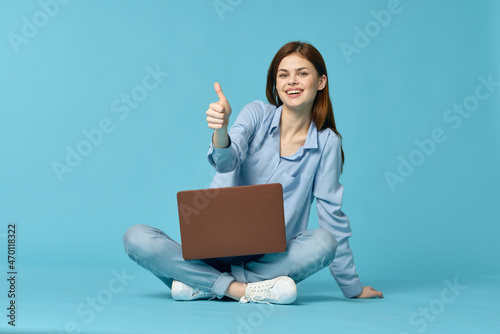 woman with laptop sitting on the floor learning student technology © VICHIZH