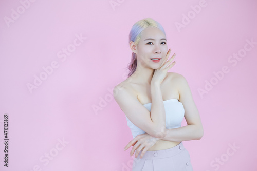 posing beautiful asia woman posing on pink background, emotions action, beauty concept