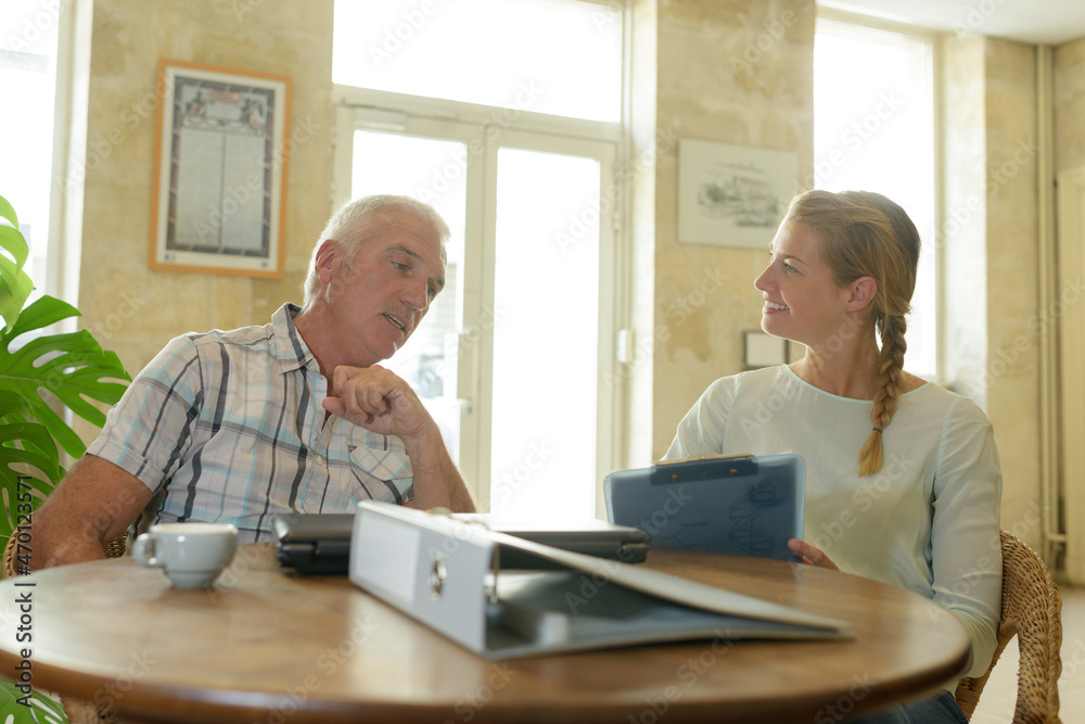 woman interviewing a middle-aged man woman interviewing a middle-aged man