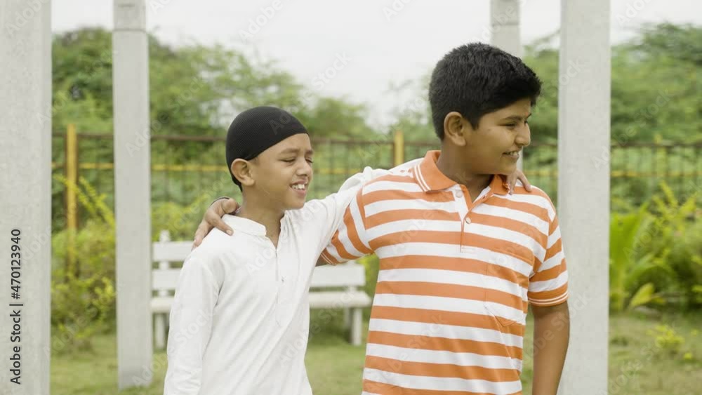 Happy multiethnic friends meeting at park and walking by placing hands on shoulder - concept of diversity, friendship and communal harmony. Happy multiethnic friends meeting at park and walking by placing hands on shoulder - concept of diversity, friendship and communal harmony.