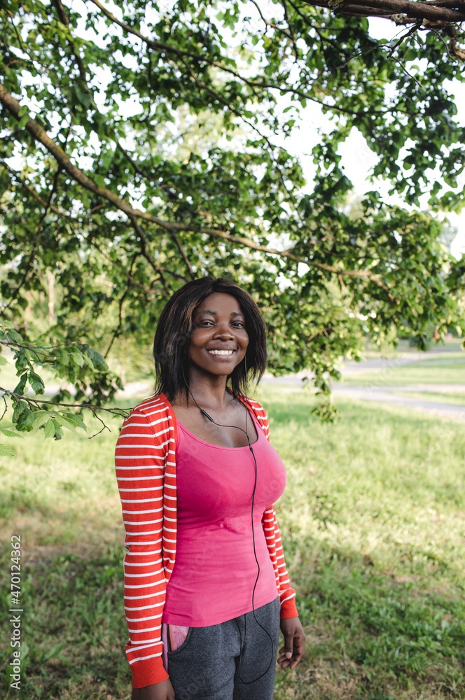 portrait of a young beautiful African American girl in a pink blouse who smiles portrait of a young beautiful African American girl in a pink blouse who smiles