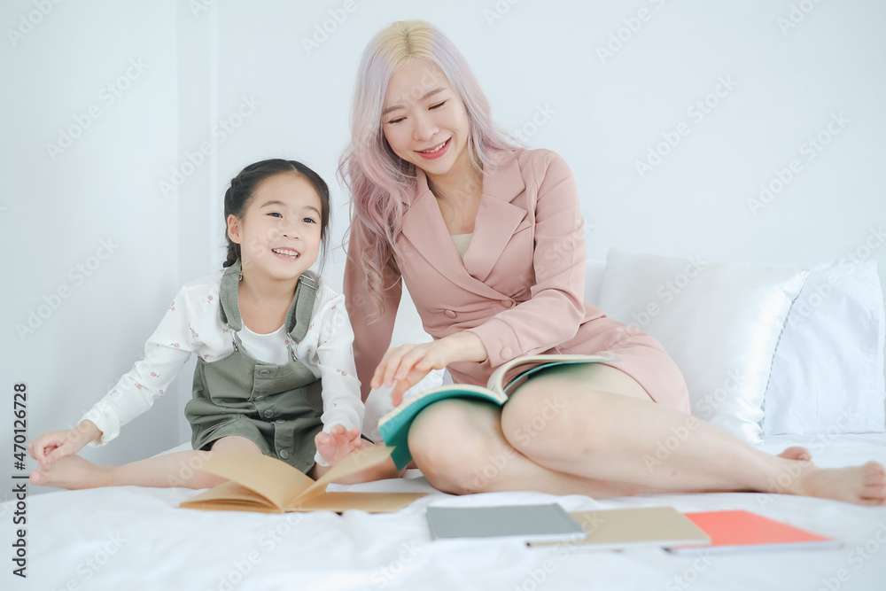 Asian little cut girl learning home school with woman teacher Asian little cut girl learning home school with woman teacher