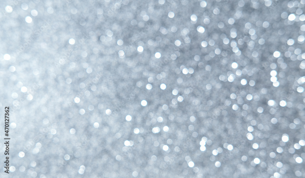 White, silver, gray Christmas background with defocused lights. Background for Valentine's Day. White or silver lights on a silver background. White, silver, gray Christmas background with defocused lights. Background for Valentine's Day. White or silver lights on a silver background.