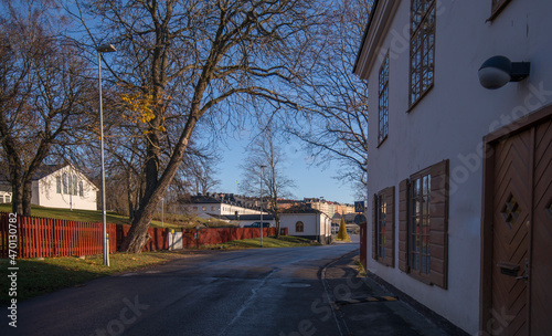 Street to the castle Karlberg between old houses from 1700s a sunny autumn day in Stockholm photo