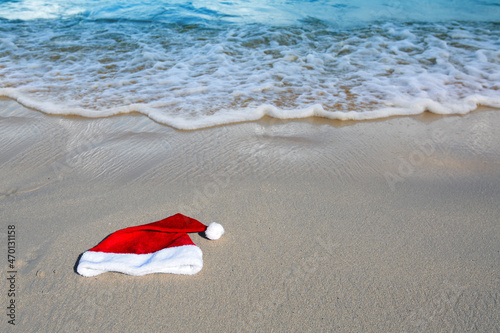 Christmas background with red Santa Hat on caribbean beach.