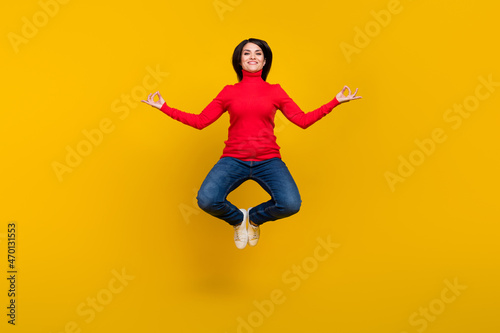 Full body portrait of cheerful carefree lady arms fingers meditate isolated on yellow color background © deagreez