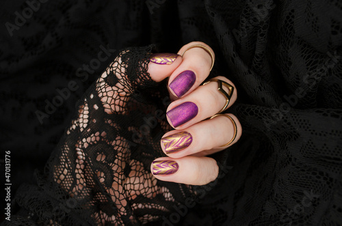 Purple matte manicure with gold abstraction. Holiday rich nail gel design.