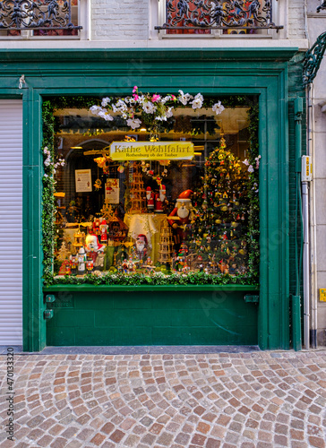 Exterior view of a Christmas gift in Belgium. Green Christmas store full whit toys in Brussel. Belgian Christmas gift shop window. Traditional Belgian architecture of a Christmas store. 