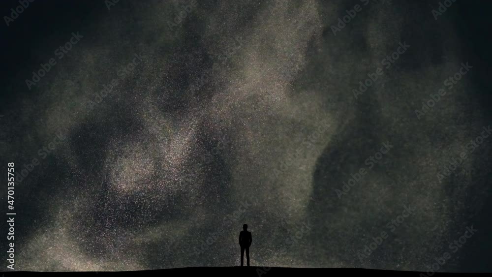 The man stands on snow falling background