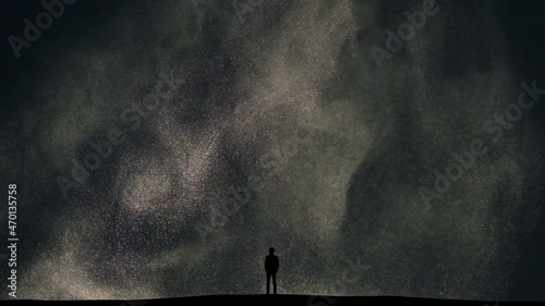 The man stands on snow falling background
