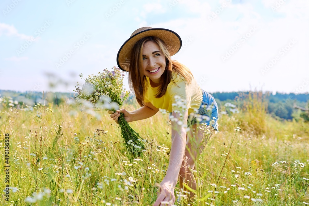 Young adult woman enjoying summer, nature, sunny meadow.