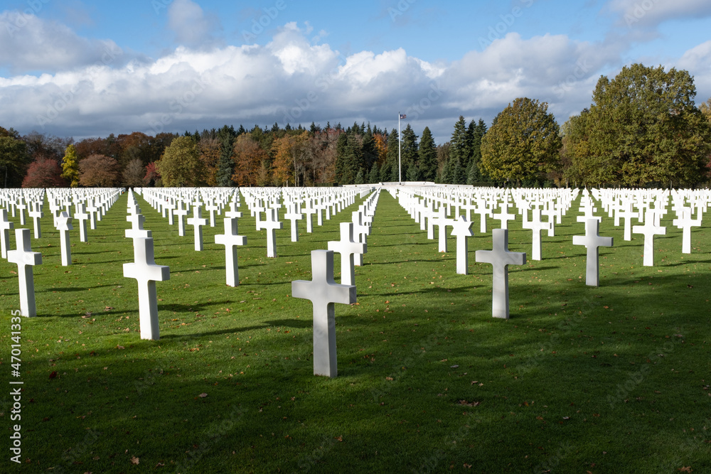 Neupre, Belgium - November 1, 2021: Ardennes American Cemetery and Memorial. Many of the burial are from the Ardennes winter offensive (Battle of the Bulge). Autumn sunny day. Selective focus.