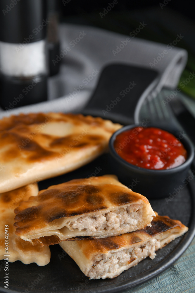 Delicious fried chebureki with ketchup on blue wooden table Delicious fried chebureki with ketchup on blue wooden table