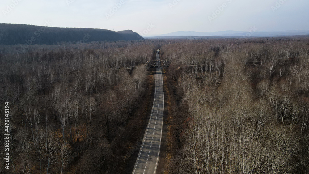 Aerial view of Car Road Under a Railway Bridge near to Mountain Ridge, Russia, Komsomolsk-on-Amure