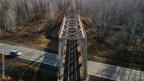 Fototapeta Naklejka Na Ścianę i Meble -  Aerial view of a Railroad Bridge above Highway, Lap, Forest, Autumn