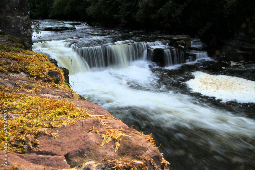 Naklejka premium A view of a small waterfall on the River Clyde at Lanark
