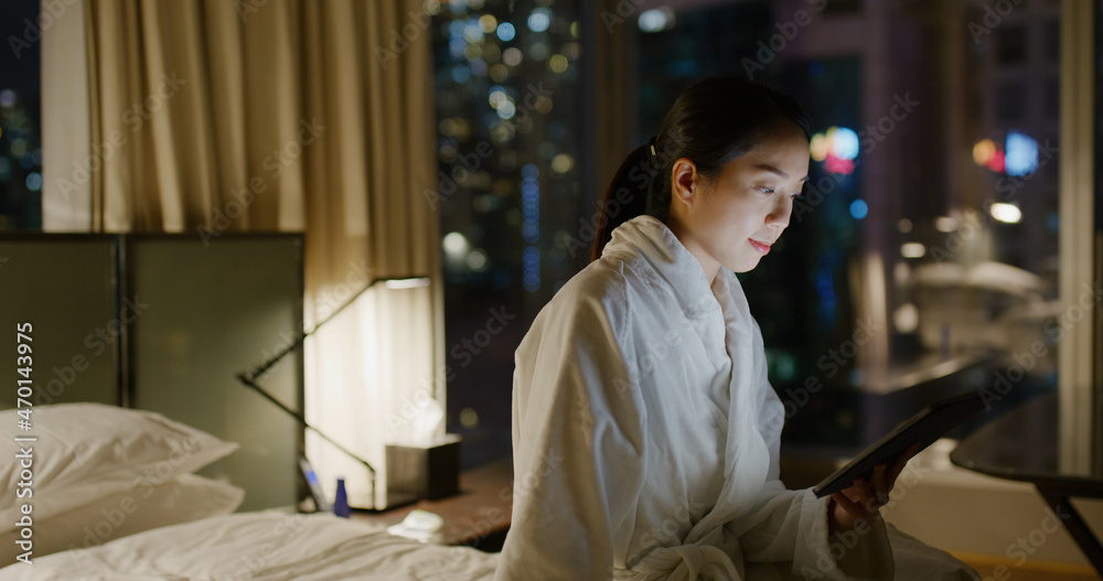 Woman use tablet computer on bed Woman use tablet computer on bed