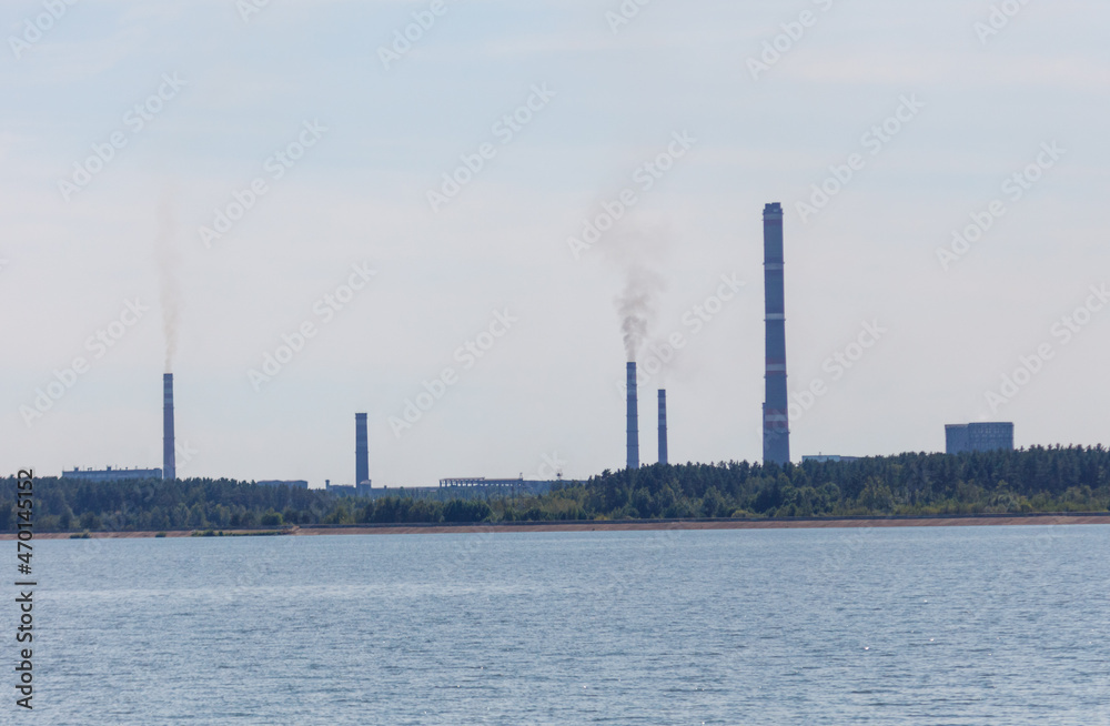 Smoke from the chimneys of the plant near the reservoir. Smoke from the chimneys of the plant near the reservoir.