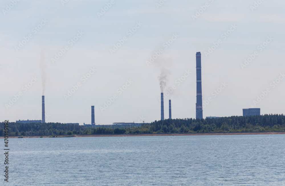 Smoke from the chimneys of the plant near the reservoir.