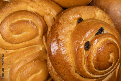 Danish bun and pretzel in the foreground of bakery or pastry composition close-up