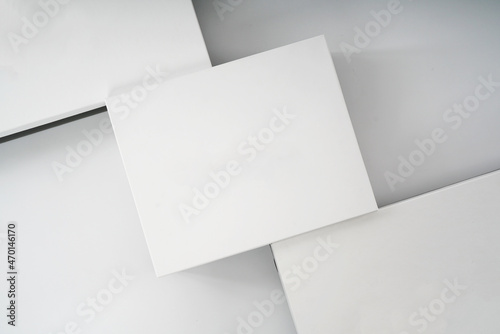 white cardboard boxes for shoes and storage of things on a light background close-up top view