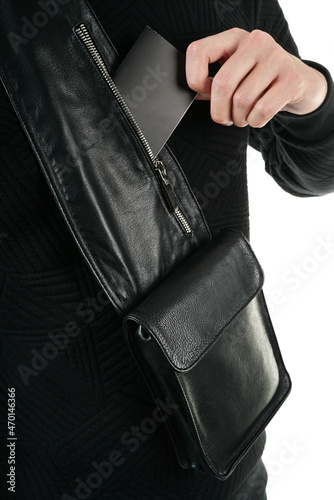 A man puts on a shoulder leather bag and advertises its appearance close up. mockup bag 