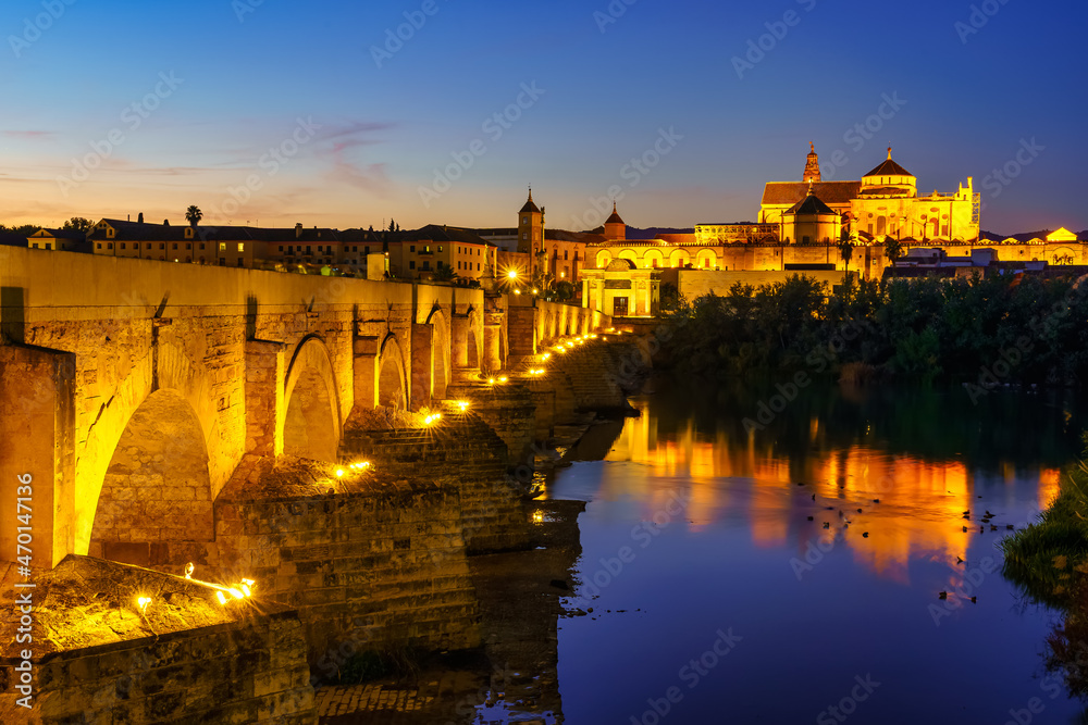 View of the city of Córdoba with its Roman bridge over the Guadalquivir river at sunset. Andalusia.