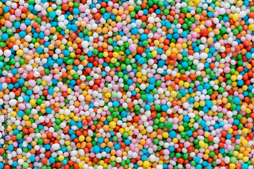 Thousands sprinkles tiny sugar beads for decorating cakes and desserts background.