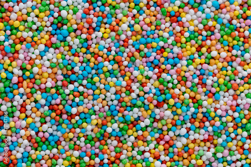 Thousands sprinkles tiny sugar beads for decorating cakes and desserts background.