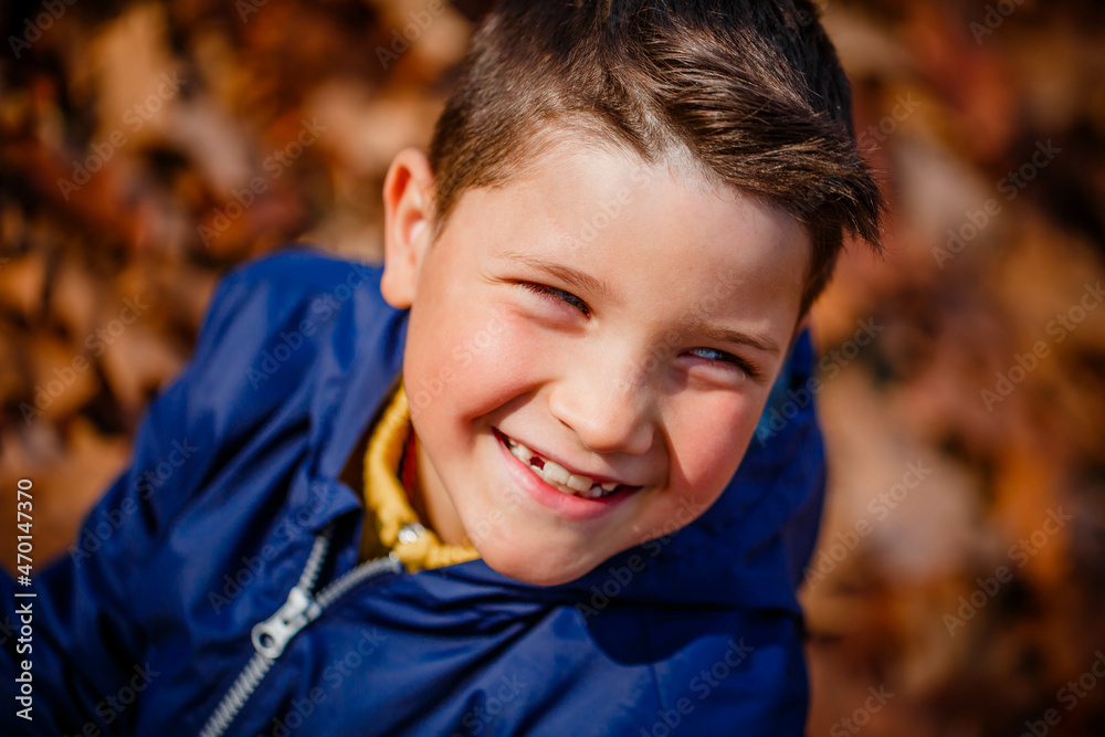 happy child laughing, dressed in a blue jacket on nature in autumn. happy child laughing, dressed in a blue jacket on nature in autumn.