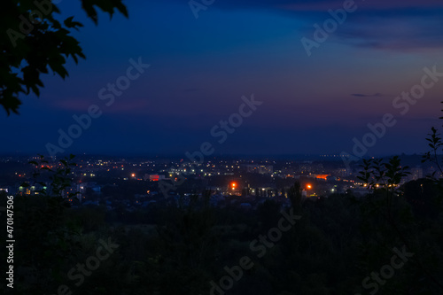 abstract unfocused fuzzy city lights illumination in twilight time after sunset foreshortening from suburban district hill top point